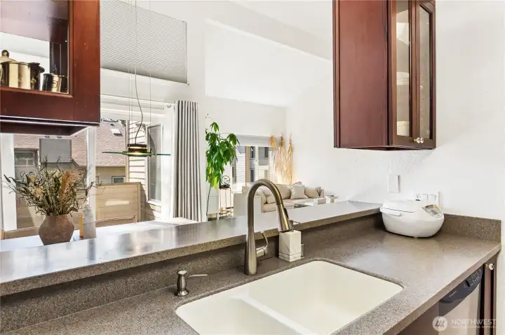 Perfect for serving up food or drinks right to the bar top or dining area with a great view of the vaulted living room. Perfect for serving up food or drinks right to the bar top or dining area with a great view of the vaulted living room.