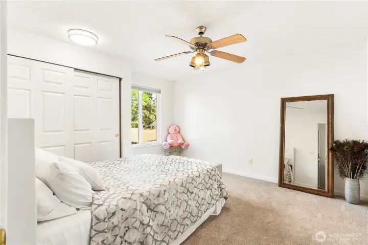 The guest bedroom is a comfortable sized room with natural warm light coming from the front of home. The guest bedroom is a comfortable sized room with natural warm light coming from the front of home.