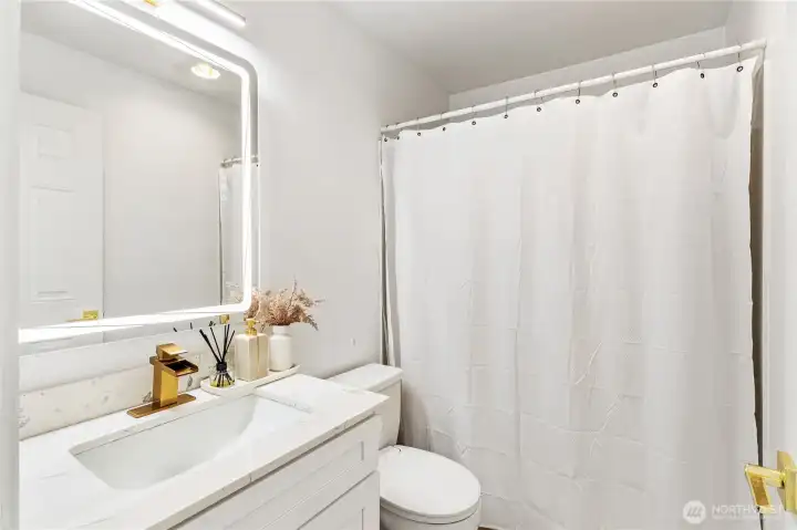 The hallway bathroom features a Full sized bathtub with brand new vanity and quartz countertop with brushed gold hardware. The bath room also has Led backlit mirrors and a bidet toilet. The hallway bathroom features a Full sized bathtub with brand new vanity and quartz countertop with brushed gold hardware. The bath room also has Led backlit mirrors and a bidet toilet.