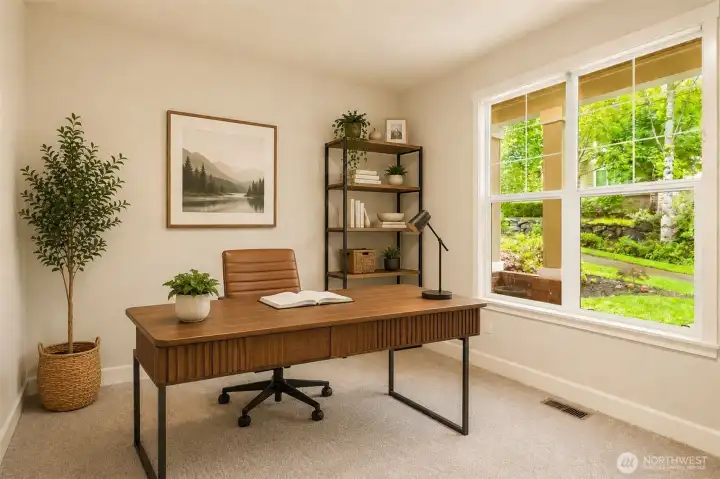 Lower level office/bedroom with large windows looking out over the lush landscaping (virtually staged)