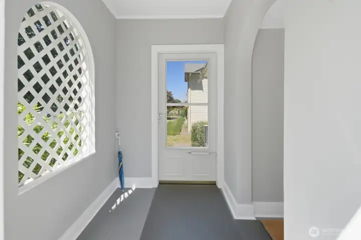 Entering through the quaint Tudor vestibule, featuring a classic arched doorway & window, showcases the original Tudor styling Entering through the quaint Tudor vestibule, featuring a classic arched doorway & window, showcases the original Tudor styling