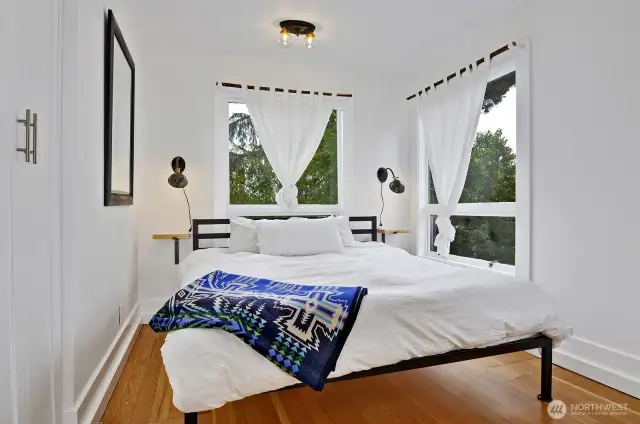 Main bedroom, this is a queen bed frame. 2 large windows to the back yard and a closet. Vintage ceiling light.