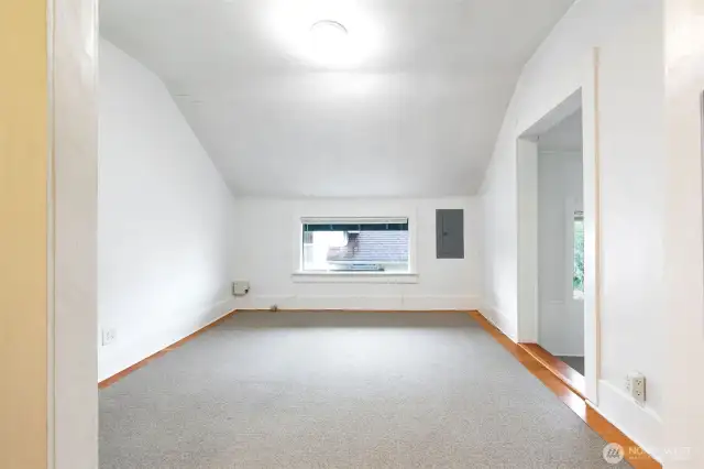 The living room, the carpet is just to protect the softwood floors. A nice long space with options for layout.