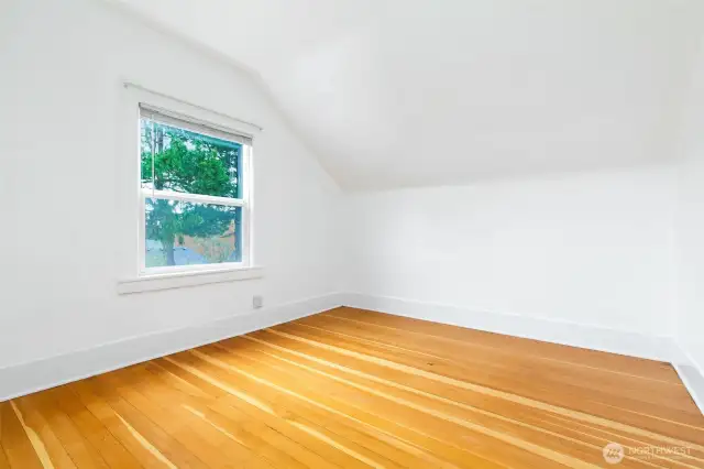 Upper unit bedroom with the fir floors.