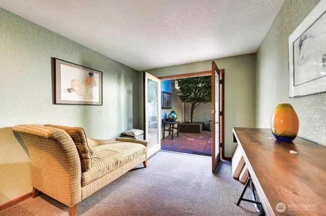 MAIN LEVEL BEDROOM WITH FRENCH DOORS TO COURTYARD