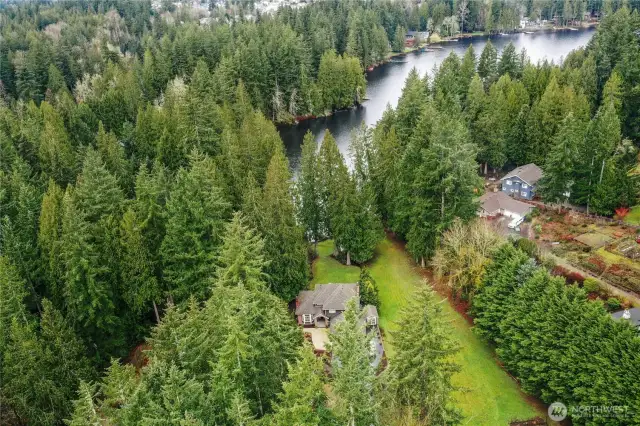 A private Sammamish retreat tucked among evergreens, this expansive lakefront estate welcomes you with manicured grounds and a lush, level lawn.