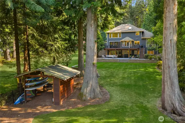 The backyard has been completely reimagined - now featuring a perfectly leveled lawn, an expansive paver patio, and a spacious composite deck designed for effortless entertaining. Enjoy serene lake views from nearly every angle, while a charming boat house keeps paddleboards, kayaks, and all your water toys close at hand. This outdoor retreat is now the ideal setting for peaceful mornings, summer barbecues, and unforgettable gatherings.