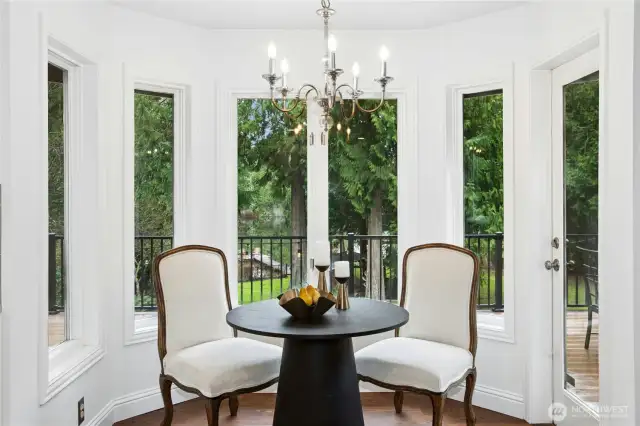 Charming breakfast nook wrapped in windows- enjoy your morning coffee overlooking lush greenery and Beaver Lake.