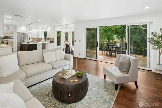 Bright and inviting great room with open-concept kitchen, rich hardwood floors, and seamless indoor-outdoor flow to the deck - perfect for lakeside entertaining in Sammamish.