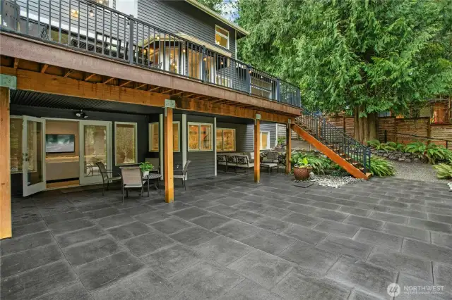 Expansive, beautifully designed two-level outdoor living space, with a composite deck (for effotless maintenanace), stone patio, and professional landscaping perfect for entertaining or relaxing by the lake.