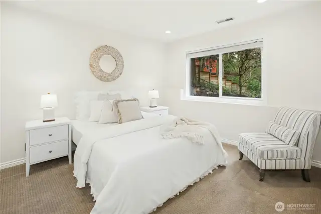 Bright and tranquil lower-level bedroom - ideal for guests, multi-gen living, or home office, just steps from the beautifully remodeled ¾ bath.