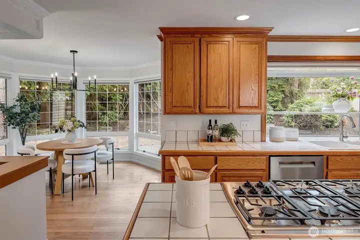 Open kitchen with eating nook and doors out to the rear yard