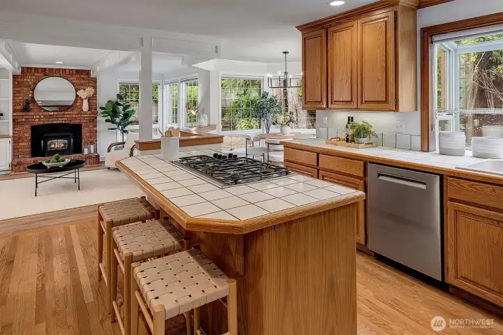 Kitchen island offers seating. Gas cooktop