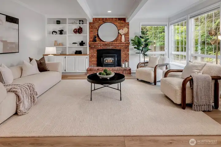 Family room off the kitchen with gas fireplace and wall of windows to the rear yard.
