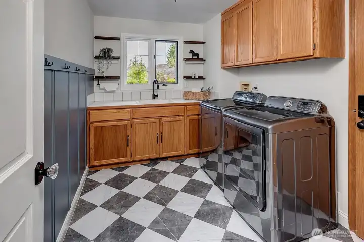 Main level laundry with folding counter, leads to garage