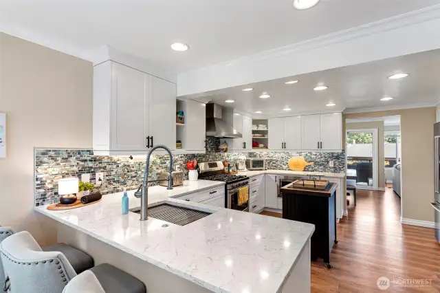 Kitchen remodel expanded the space and created new counter seating and this ideal gathering place. Gas range is an added bonus as the gas utility is included in the HOA!