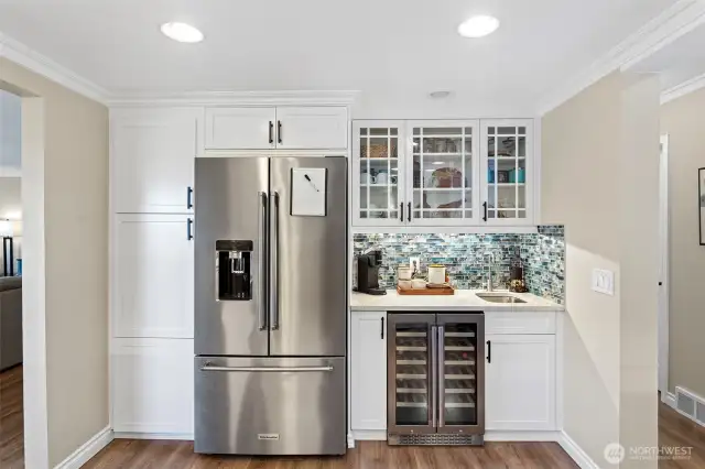 The kitchen's high-end upgrades include KitchenAid appliances, a wine cooler, and a second prep sink with instant hot water dispenser.