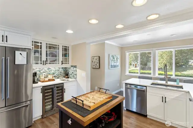 Expansive windows in the kitchen fill the room with light and provide views while preparing meals and entertaining in the kitchen.