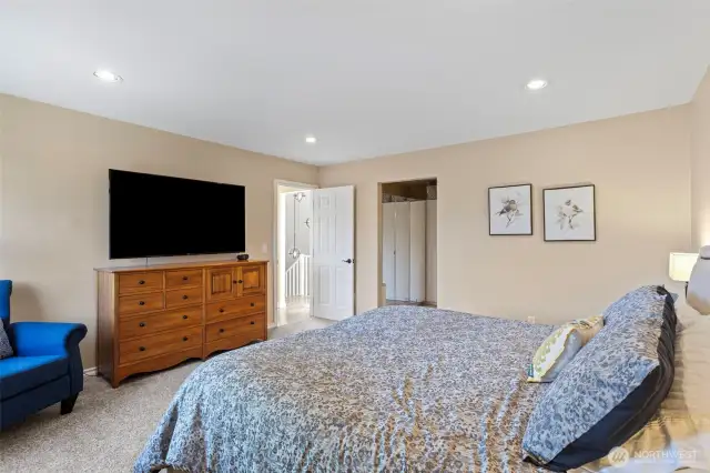 Go ahead, splurge and fill this enormous   primary bedroom with all the comfy,   oversized furniture your heart desires!