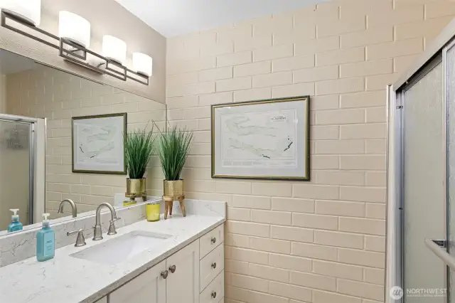 This full bathroom features new vanity, new fixtures as well as a tub when you feel the need to soak.
