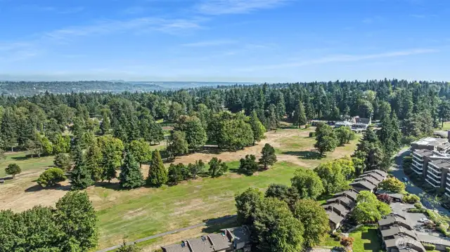 The condo community sit adjacent to the golf course and is surrounded by evergreen trees and vast open space.