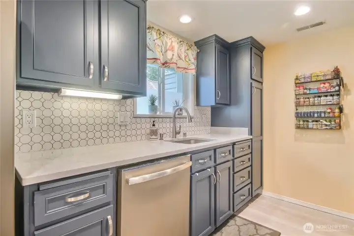 Updated kitchen with stone countertops, tile backsplash