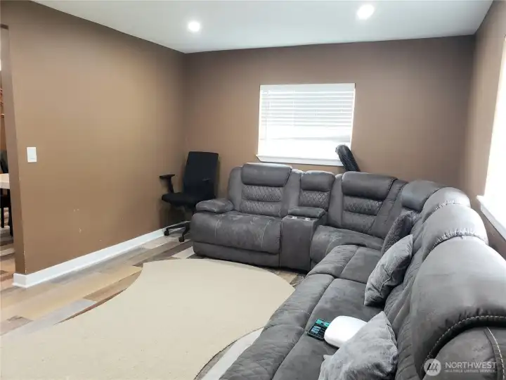 A Different view of the Huge Entertaining Living Room Showing Fresh Paint, Trim and Vinyl Plank Flooring.