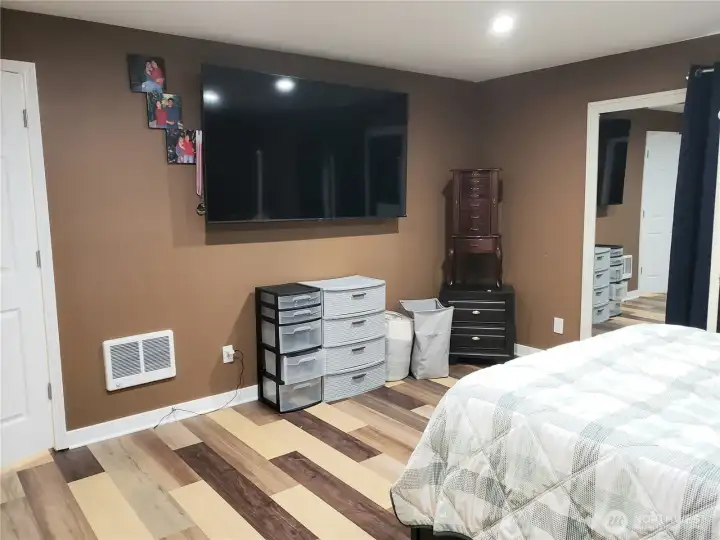View of the Primary Master Bedroom Showing New Paint, Trim Led Lighting and Vinyl Plank Flooring.