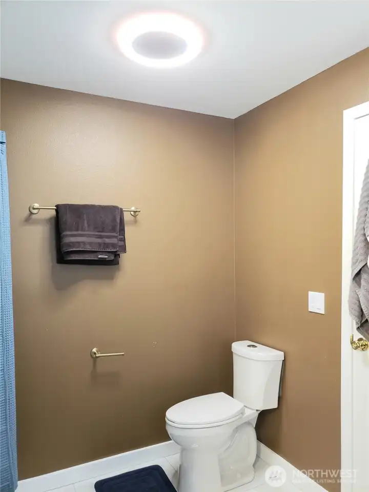 Another Close up view of the Primary Master Bath Room Showing New Toilet with New Paint, Trim and Tile Flooring.