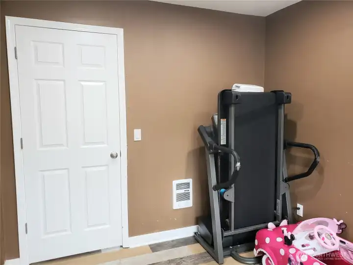 Opposite View of the Large Third Bedroom with New Paint, Trim, LED Lighting and Vinyl Plank Flooring.