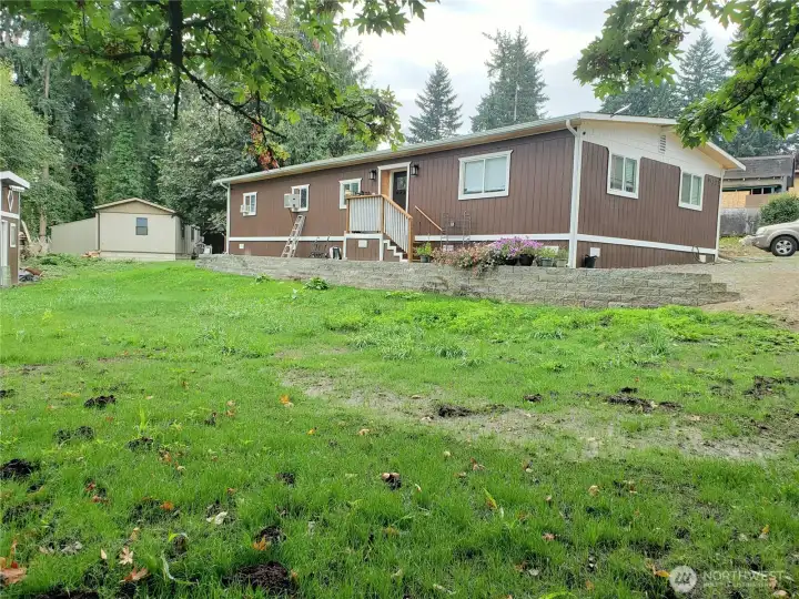 A View of the Huge Back Yard of the Home with New Deck and Retaining Wall.