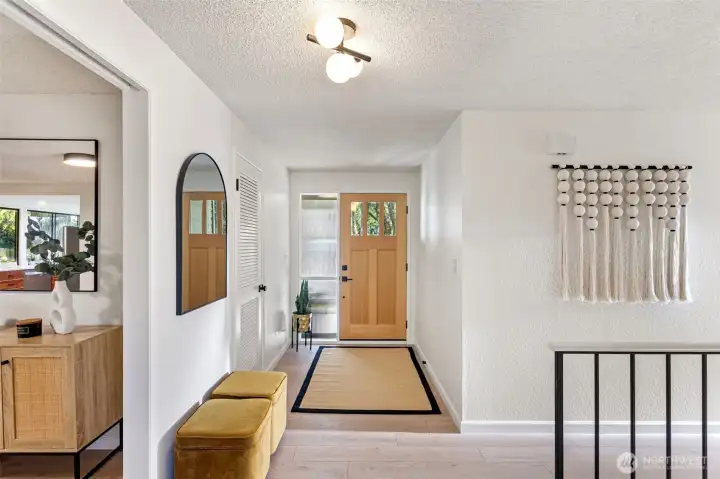 Enter through a covered front porch, with a new solid fir wood door that leads to a formal entry with guest coat closet and space to kick off your shoes.