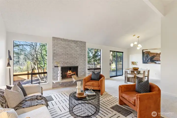 As you enter this home, take in the breathtaking private yard with mature trees through expansive living room windows.