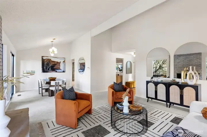 The spacious living room is connected to the dining room for easy entertaining, and features new wall-to-wall carpet and fresh paint.