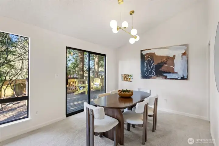 The spacious dining room features vaulted ceilings and a new statement chandelier.