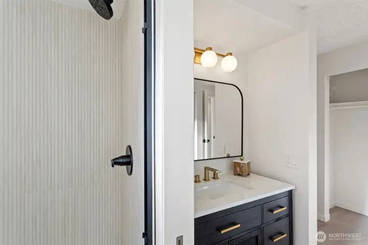 Newly refreshed en-suite bath features new vanity, brushed gold faucet, shower pan and surround and flooring.  It also has a second closet.
