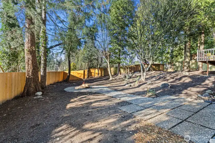 The private backyard boasts a brand new fence on the south side of the lot, mature trees with paths and plenty of room to roam.
