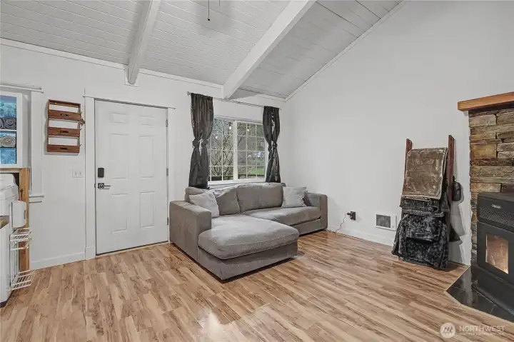 View of your front door and living room, stove to your right keeps the whole cabin cozy on cooler days and nights.