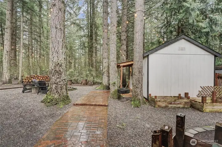 Pathway from your deck to your additional storage shed, currently used as a guest bedroom.