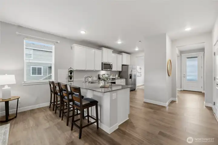 large counter with breakfast bar, perfect for eating and entertaining