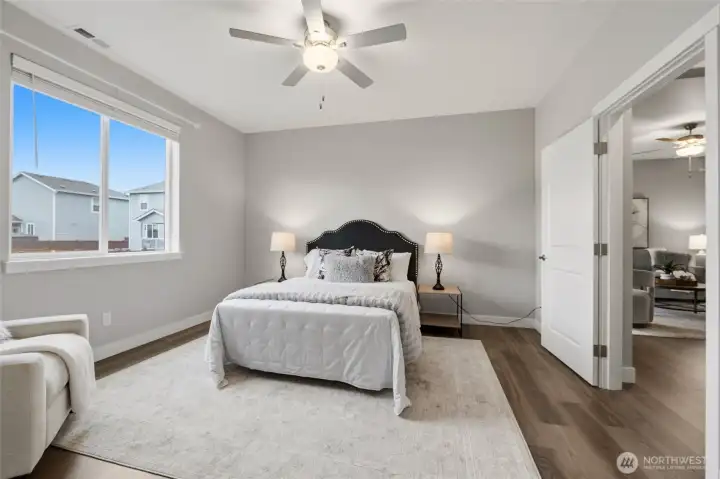 Primary bedroom with overhead fan