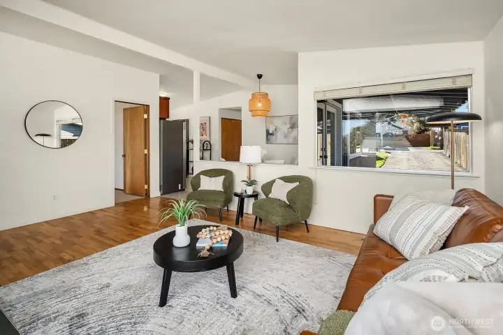The family room is through the door to the right of the mirror.
