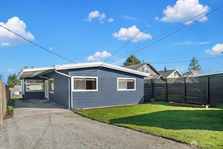 Covered side patio perfect for grilling or sitting outside year round. Fenced back yard with rolling gate.
