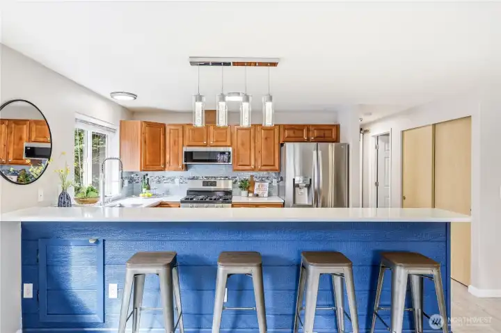 Have guests over as you cook up a masterpiece! Love the quartz countertops!