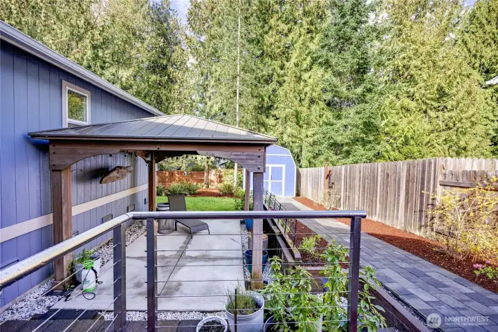 Beyond the gate is a beautifully landscaped backyard.