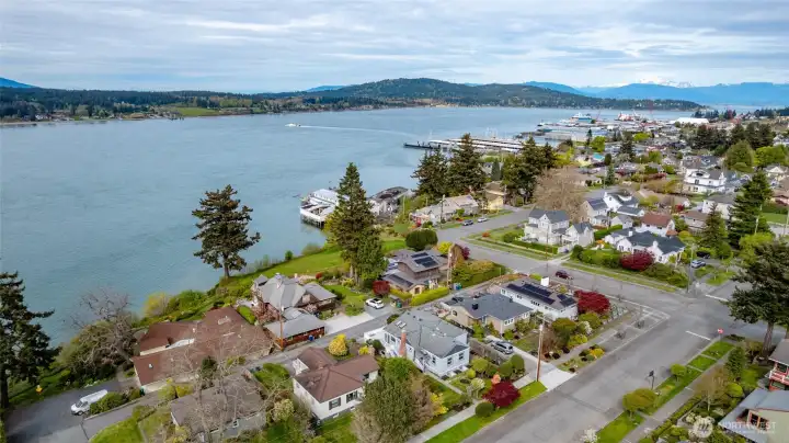 View of the home to the East. Downtown Anacortes is a short drive or walk away. The Cascade Mountains are seen in the distance.