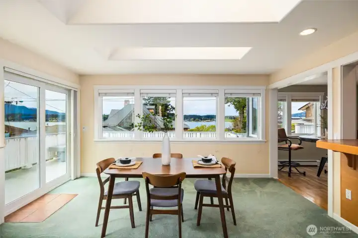 Dining room with sliding glass doors and lots of windows for the exquisite view.