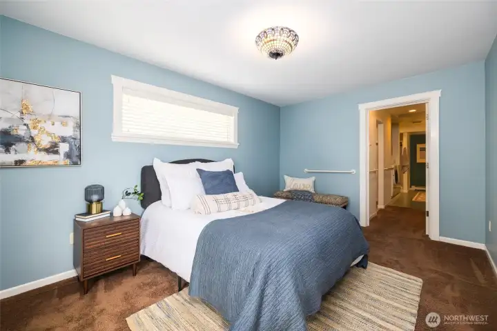 Primary bedroom also has sliders out to deck and a view of the water.