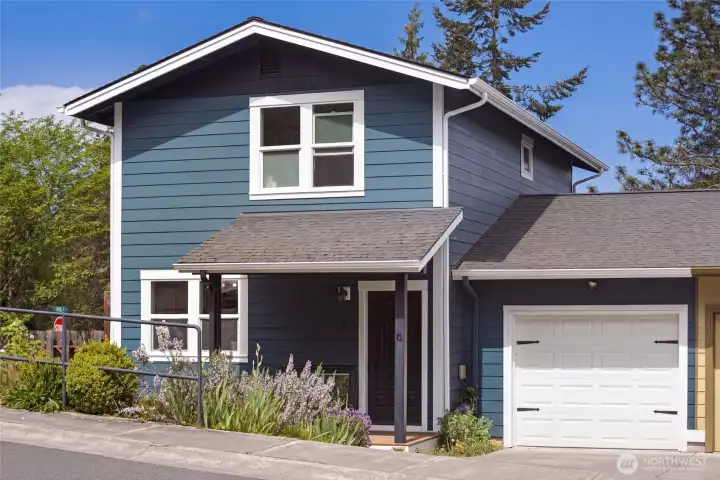 The bold blue craftsman exterior with crisp white trim makes a memorable first impression, while the attached single-car garage and covered front entry offer everyday convenience in a charming, well-maintained in-town setting.
