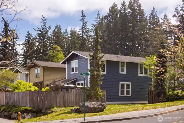 Situated on a corner at Park Street, the home's striking blue craftsman silhouette stands beautifully against a backdrop of towering Pacific Northwest conifers, just moments from downtown Friday Harbor's shops, library, and waterfront.